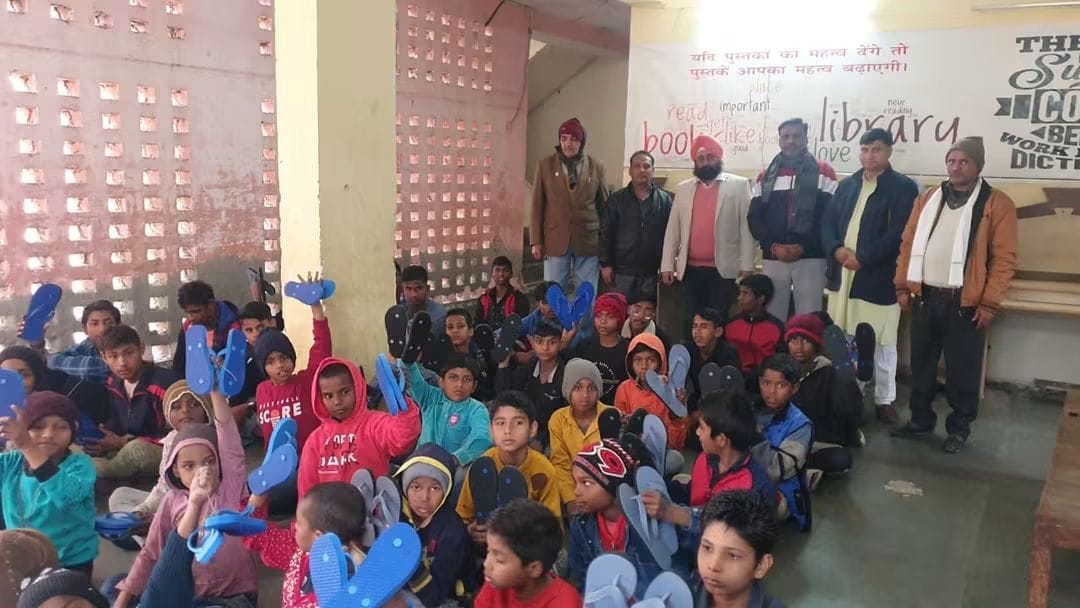 Children receiving footwear during an AAS India Foundation support drive