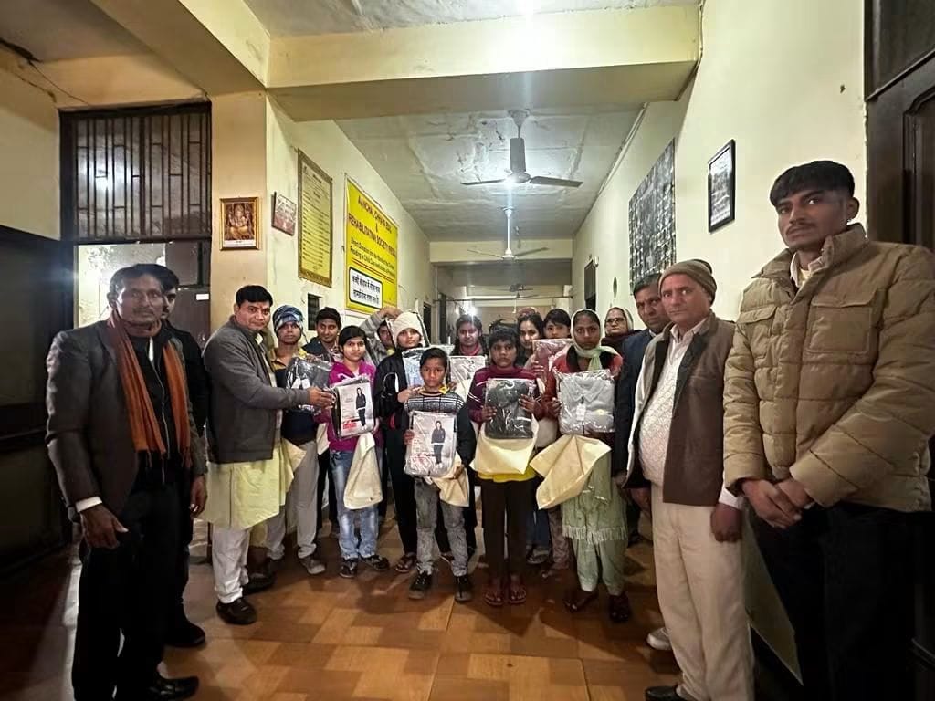 Children receiving warm clothing during a support drive